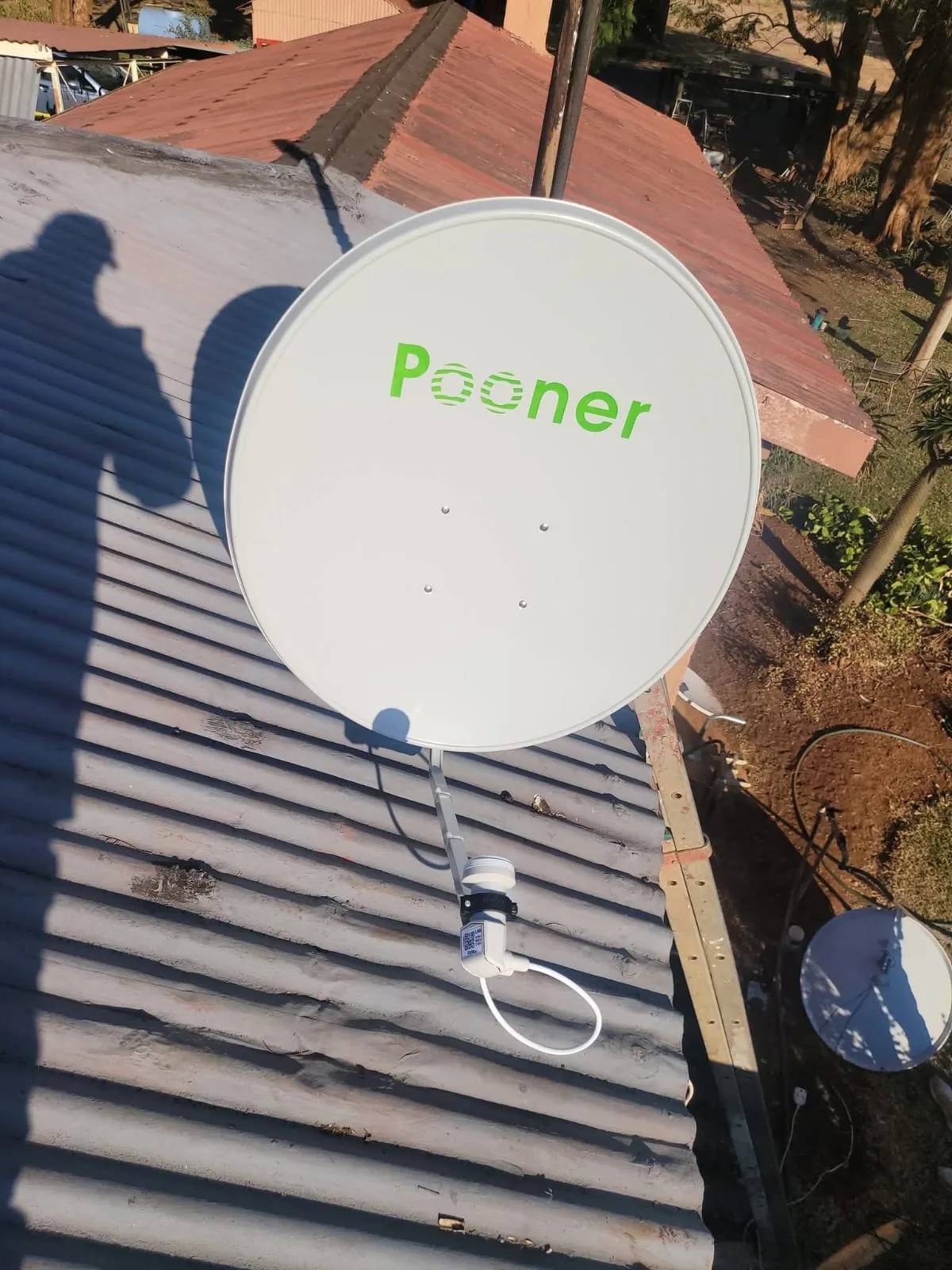 DSTV-compatible Pooner dish installed on a corrugated iron roof